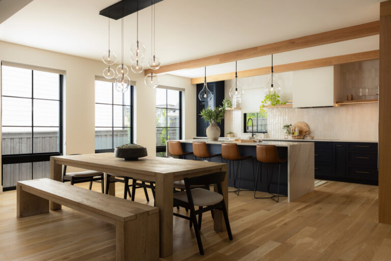 Smart kitchen in an Eldorado custom home featuring large windows, natural wood floors, exposed beams, and integrated smart lighting