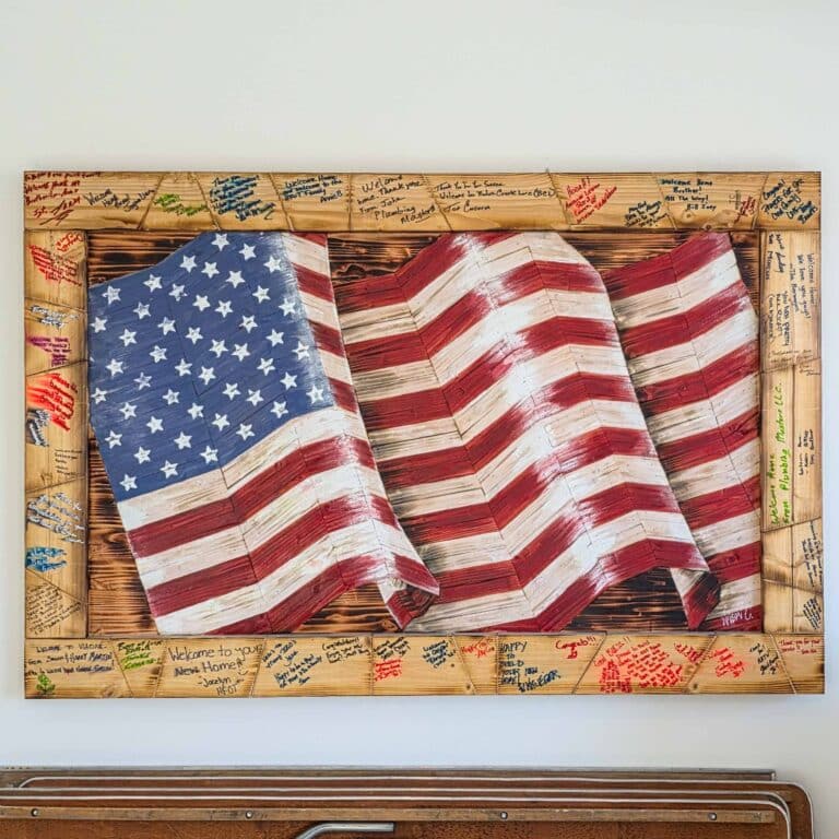 Our Lead Carpenter, Nelson, painted and built a wooden flag at all Homes For Our Troops Homes using 2x4's that the community wrote kind words on.