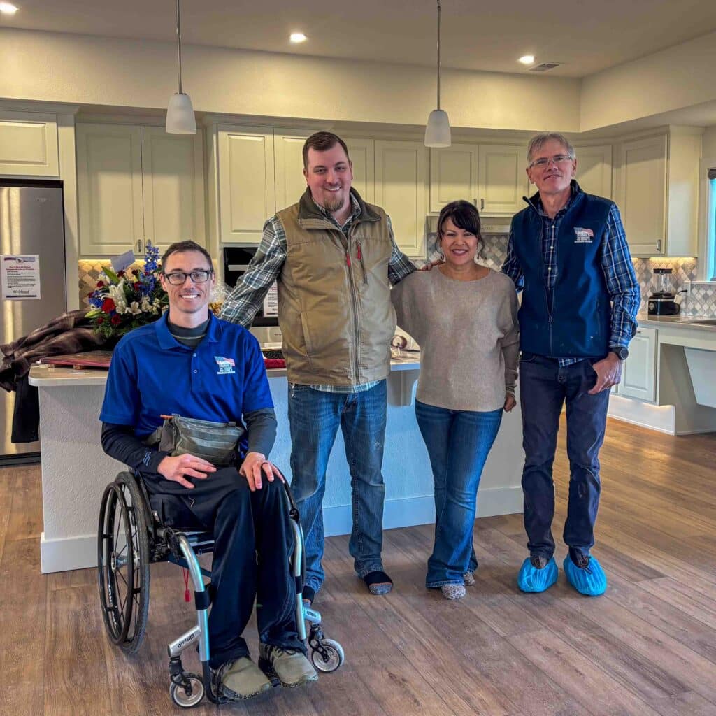 SSG Brian Price and three of our project managers, Ejliah, Heather, and Warren Krueger taking a photo in SSG Brian Price's new kitchen.