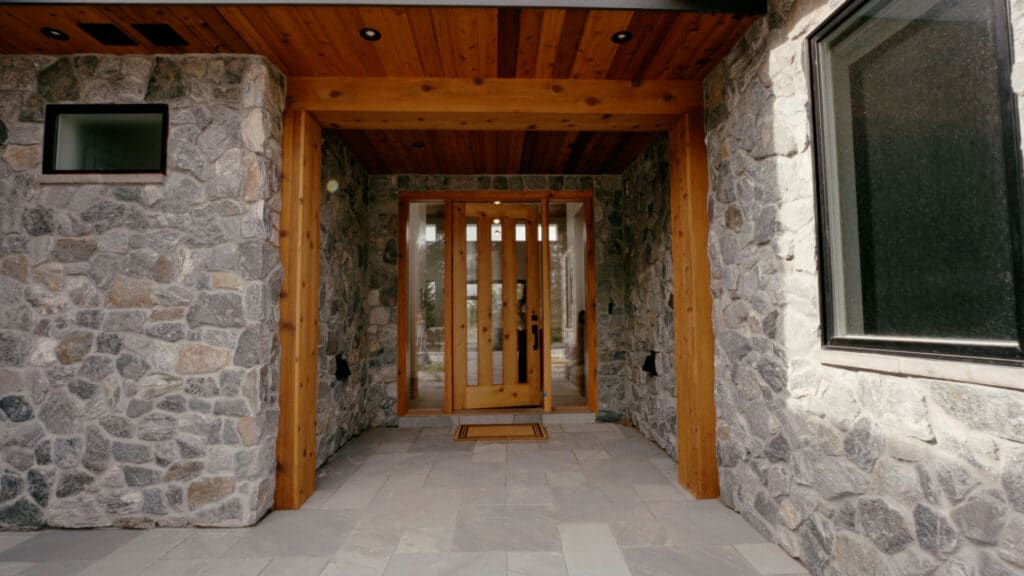Two people closing the front door on a Built by Krueger home