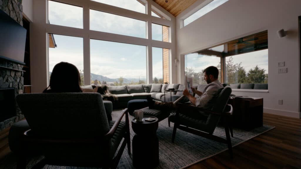 A couple reading a newspaper in the living room of their home