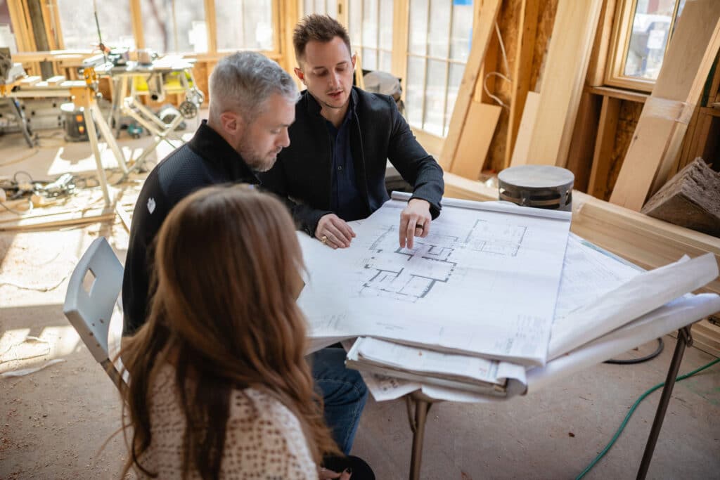 Discussing architectural plans in construction site