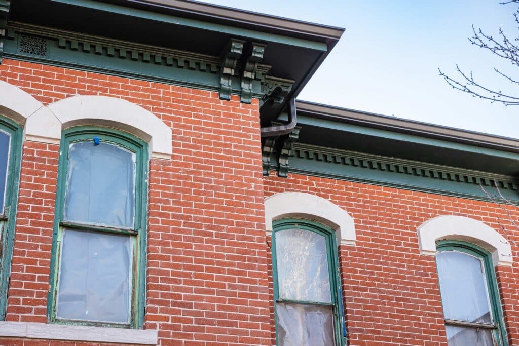 Red brick building with green accents.